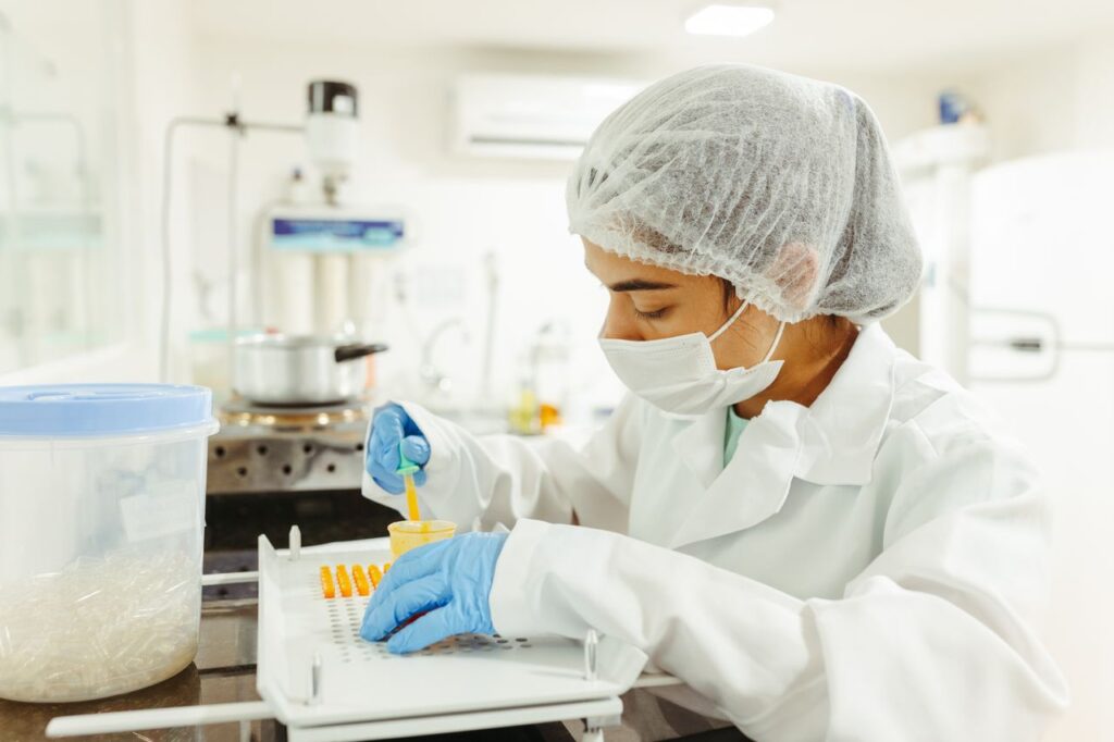 Scientist in a laboratory working with vials and pipettes