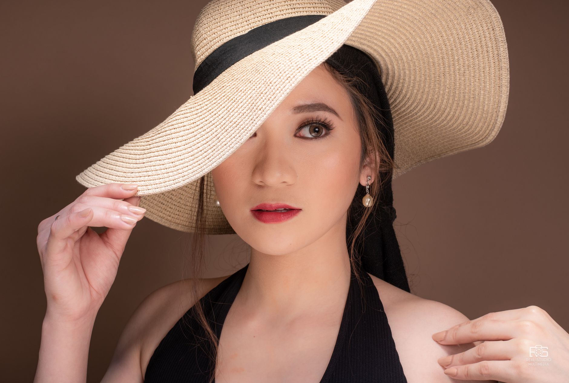 Close-up portrait of a beautiful Asian woman wearing a summer hat, with flawless skin and red lips. — Products You Can Easily