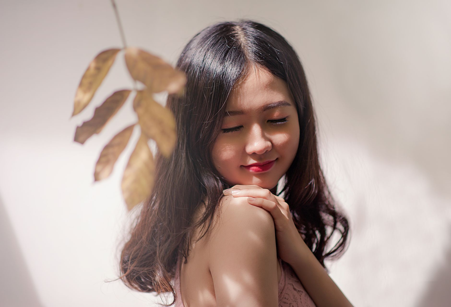 Peaceful young woman with eyes closed, embracing serenity with a gentle smile. — PRP Facial for Fine Lines and Wrinkles Expla