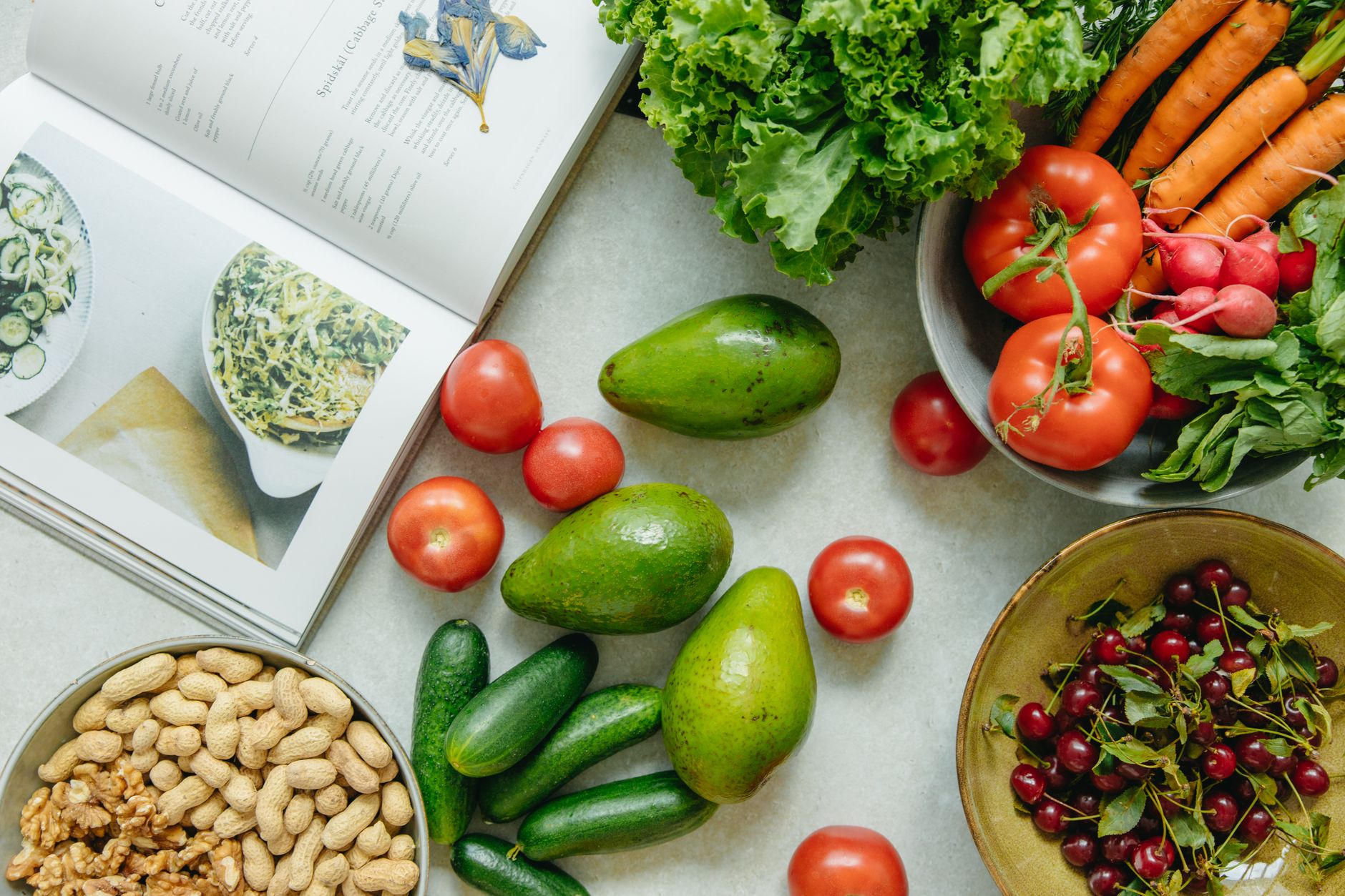 An appetizing display of fresh fruits and vegetables with a cookbook, perfect for healthy recipes. — Revamp Your Snacking: De